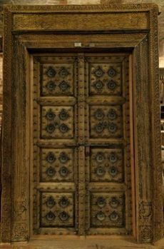 Antique Carved Wooden Door with Metal Fittings and Frame