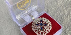 STERLING SILVER PLATED RING WITH FIVE BLUE SAPPHIRE STONES