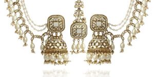 Traditional gold-plated Jhumka Earrings with Kundan and Mirror Work, Featuring Multiple Pearl Chains