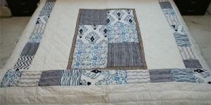 patch-block print bed-sheet quilt