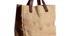 NATURAL JUTE BAG WITH REXINE HANDLE .