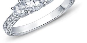 an Antique Scroll Design Three Stone Engagement Ring with Center Diamond