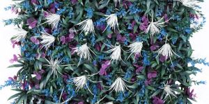 white purple flowers blue green leaves artificial green wall