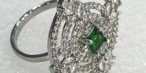 SILVER-PLATED ADJUSTABLE RING WITH EMERALD AND CZ STONES