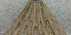 Women Motif And Zircon Diamond Work Studded Golden Color Net Lehenga Choli