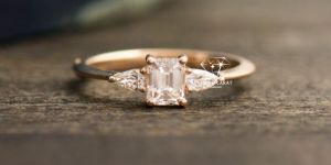 Unique Emerald and Pear Cut Three Diamond Engagement Ring